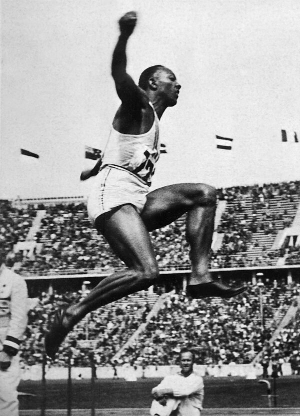 US champion Jesse (James Cleveland) Owens is airborne during the long jump event, that he won, 09 August 1936 during Olympic Games in Berlin. (File) US champion Jesse (James Cleveland) Owens is airborne during the long jump event, that he won, 09 August 1936 during Olympic Games in Berlin. (File) - Sputnik International