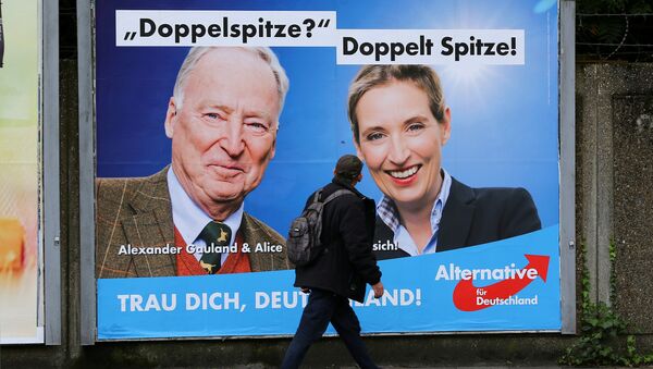 A man looks at at a placard of Alexander Gauland and Alice Weidel, the top candidates of Germany's anti-immigration party Alternative fuer Deutschland AfD for the September 24 federal election, in Marxloh, a suburb of Duisburg which local media said is populated mostly with people of Turkish migrant background, Germany September 13, 2017 - Sputnik International
