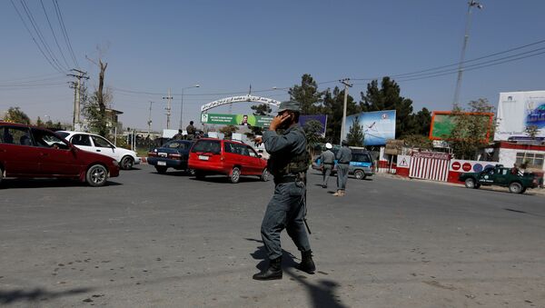 Afghan policemen stand guard outside of Kabul Airport after rockets exploded in Kabul, Afghanistan - Sputnik International