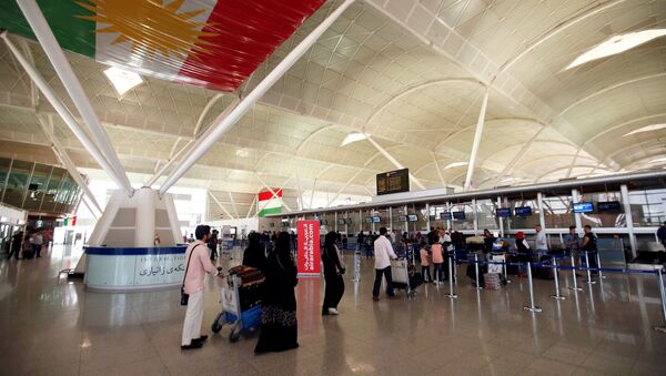 Passengers walk towards the check-in counters at Erbil International Airport, Iraq September 27, 2017 - Sputnik International
