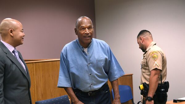 O.J. Simpson gets up as his lawyer Malcolm LaVergne looks on during his parole hearing at Lovelock Correctional Center in Lovelock, Nevada, U.S., July 20, 2017 - Sputnik International
