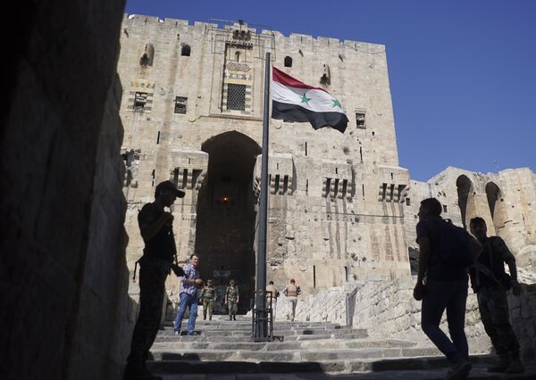 People walk into the Citadel, Aleppo's famed fortress where much of the fierce fighting took place in 2016, in Syria, Tuesday, Sept. 12, 2017 People walk into the Citadel, Aleppo's famed fortress where much of the fierce fighting took place in 2016, in Syria, Tuesday, Sept. 12, 2017 - Sputnik International
