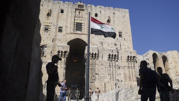 People walk into the Citadel, Aleppo's famed fortress where much of the fierce fighting took place in 2016, in Syria, Tuesday, Sept. 12, 2017 - Sputnik International