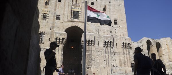 People walk into the Citadel, Aleppo's famed fortress where much of the fierce fighting took place in 2016, in Syria, Tuesday, Sept. 12, 2017 People walk into the Citadel, Aleppo's famed fortress where much of the fierce fighting took place in 2016, in Syria, Tuesday, Sept. 12, 2017 - Sputnik International