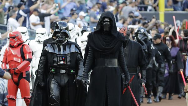 Fans watch as people dressed as characters from the movie Star Wars walk on the field before a baseball game between the New York Yankees and the Seattle Mariners on Friday, Aug. 25, 2017, in New York - Sputnik International