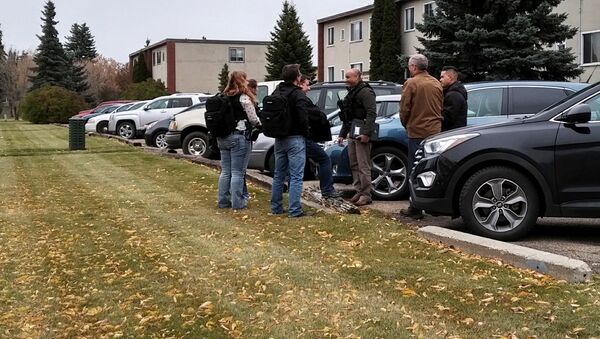 Plainclothes police gather outside an apartment building near downtown Edmonton, Alberta, Canada October 1, 2017 after a refugee was accused of stabbing an officer and running down four pedestrians in a car - Sputnik International