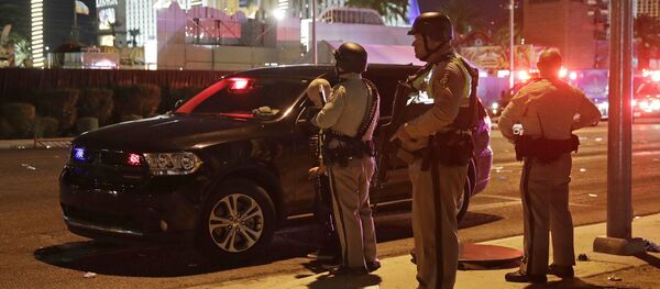 Police stand at the scene of a shooting along the Las Vegas Strip, Monday, Oct. 2, 2017, in Las Vegas Police stand at the scene of a shooting along the Las Vegas Strip, Monday, Oct. 2, 2017, in Las Vegas - Sputnik International