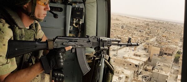In this Friday, Sept. 15, 2017 file photo, a Russian soldier guards as a military helicopter flies over Palmyra, Syria In this Friday, Sept. 15, 2017 file photo, a Russian soldier guards as a military helicopter flies over Palmyra, Syria - Sputnik International