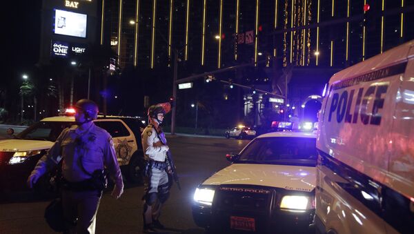 Police officers stand along the Las Vegas Strip outside the Mandalay Bay resort and casino during a deadly shooting near the casino, Sunday, Oct. 1, 2017, in Las Vegas - Sputnik International