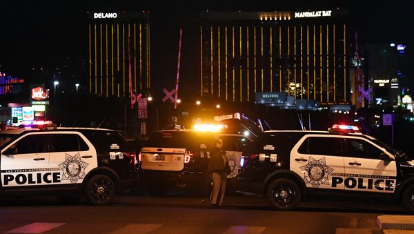 Police form a perimeter around the road leading to the Mandalay Hotel (background) after a gunman killed at least 50 people and wounded more than 200 others when he opened fire on a country music concert in Las Vegas, Nevada - Sputnik International
