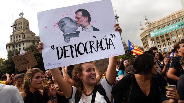 A woman holds up a banner reading Democracy depicting former Spanish dictator Francisco Franco kissing Spanish Prime Miniser Mariano Rajoy during a protest one day after the banned independence referendum in Barcelona, Spain, October 2, 2017. - Sputnik International