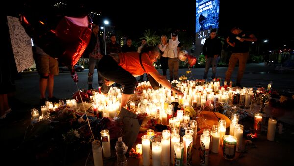 People gather at a vigil on the Las Vegas strip following a mass shooting at the Route 91 Harvest Country Music Festival in Las Vegas, Nevada, U.S., October 3, 2017 - Sputnik International