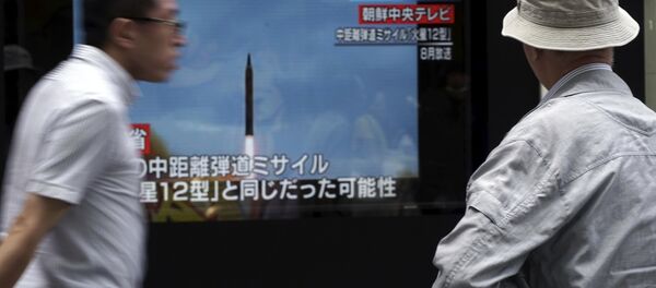 A man, right, watches a public TV screen broadcasting news of North Korea's launch of missile, in Tokyo A man, right, watches a public TV screen broadcasting news of North Korea's launch of missile, in Tokyo - Sputnik International