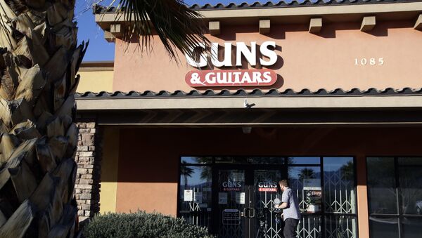 A member of the media takes video footage of the front of the Guns & Guitars store in Mesquite, Nev., Monday, Oct. 2, 2017 - Sputnik International