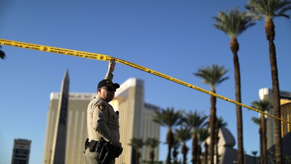 A police officer stands in front of the closed Las Vegas Strip next to the site of the Route 91 music festival mass shooting outside the Mandalay Bay Resort and Casino in Las Vegas, Nevada, U.S - Sputnik International
