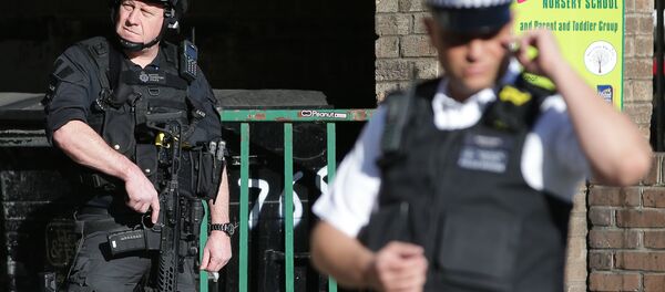 Armed British police officers stand on duty outside Parsons Green underground tube station in west London on September 15, 2017, following an incident on an underground tube carriage at the station - Sputnik International