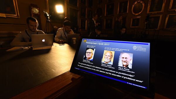 Laureates (L-R) Rainer Weiss, Barry C Barish and Kip S Thorne are pictured on a display during the announcement of the 2017 Nobel Prize winners in Physics on October 3, 2017, at the Royal Swedish Academy of Sciences in Stockholm - Sputnik International