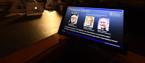 Laureates (L-R) Rainer Weiss, Barry C Barish and Kip S Thorne are pictured on a display during the announcement of the 2017 Nobel Prize winners in Physics on October 3, 2017, at the Royal Swedish Academy of Sciences in Stockholm - Sputnik International