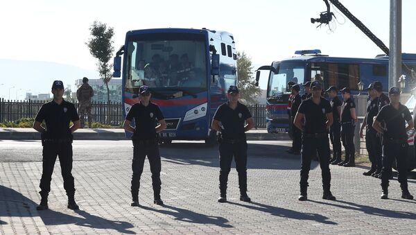 Riot police stand guard as prison vehicles, carrying soldiers accused of attempting to assassinate Turkish President Tayyip Erdogan on the night of the failed last year's July 15 coup arrive for a trial in Mugla, Turkey - Sputnik International