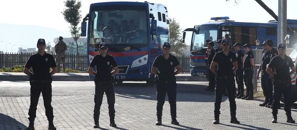 Riot police stand guard as prison vehicles, carrying soldiers accused of attempting to assassinate Turkish President Tayyip Erdogan on the night of the failed last year's July 15 coup arrive for a trial in Mugla, Turkey Riot police stand guard as prison vehicles, carrying soldiers accused of attempting to assassinate Turkish President Tayyip Erdogan on the night of the failed last year's July 15 coup arrive for a trial in Mugla, Turkey - Sputnik International
