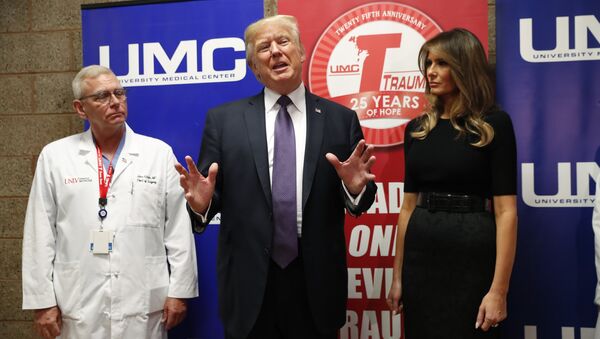 U.S. President Donald Trump speaks with reporters with first lady Melania Trump and UNLV Trauma Center Medical Director John Fildes after meeting with patients in the wake of the mass shooting in Las Vegas, Nevada, U.S., October 4, 2017 - Sputnik International