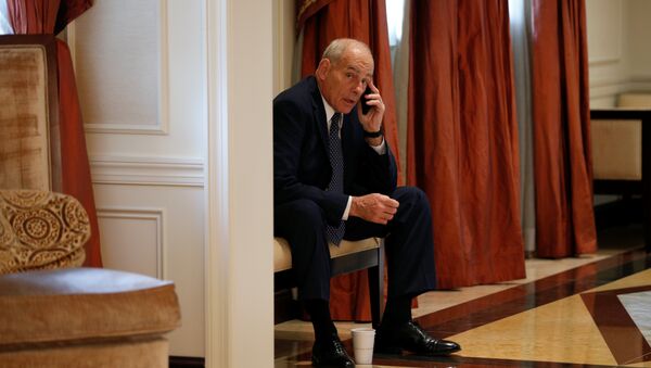 White House Chief of Staff John Kelly speaks on his phone in a hallway outside the room where U.S. President Donald Trump was meeting with Ukraine President Petro Poroshenko during the U.N. General Assembly in New York, U.S., September 21, 2017. - Sputnik International