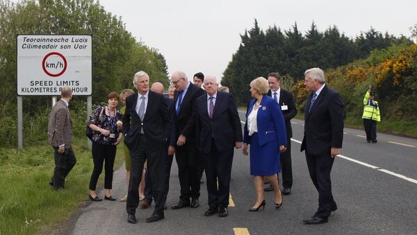 The European Union's chief negotiator Michel Barnier, front left, and Charles Flanagan, center, Minister for Foreign Affairs walk along the Irish border close to Castleblayney, Ireland, Friday, May 12, 2017. - Sputnik International