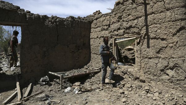 Afghan security police stand guard at the destroyed house after an operation in Asad Khil near the site of a U.S. bombing in the Achin district of Jalalabad, east of Kabul, Afghanistan - Sputnik International