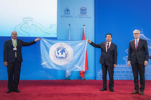 In this photo provided by Interpol, a Palestinian delegate receives the INTERPOL flag from the president of the International Criminal Police Organization Meng Hongwei second right, during the Interpol General Assembly, in Beijing, China, Wednesday, Sept. 27, 2017 - Sputnik International