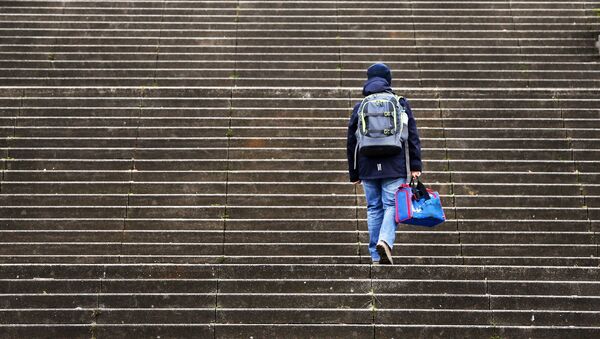 A boy walks up stairs on his way to school in Frankfurt, Germany, Tuesday, March 14, 2017 - Sputnik International