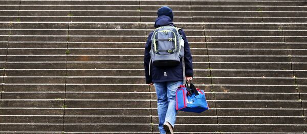 A boy walks up stairs on his way to school in Frankfurt, Germany, Tuesday, March 14, 2017 - Sputnik International