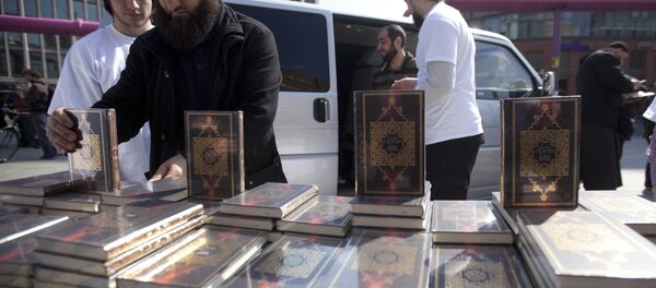 Members of a Muslim group pile Qurans while distributing copies of it at Potsdamer Platz in Berlin. (File) Members of a Muslim group pile Qurans while distributing copies of it at Potsdamer Platz in Berlin. (File) - Sputnik International