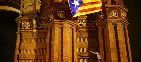 A man waves a separatist Catalonian flag at a pro-independence rally in Barcelona, Spain A man waves a separatist Catalonian flag at a pro-independence rally in Barcelona, Spain - Sputnik International