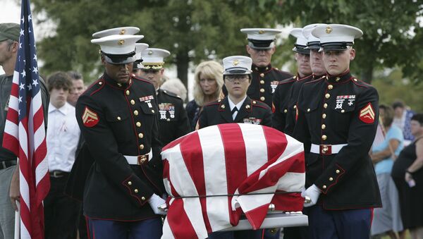 An American flag covers the casket of Lance Cpl. Christopher Fowlkes as it is carried by an honor guard during grave side services Friday, Sept. 18, 2009, in Gaffney, S.C. Fowlkes, 20, died last week from his injuries from a ground bomb on Sept. 3 battle in Helmand province, Afghanistan. - Sputnik International
