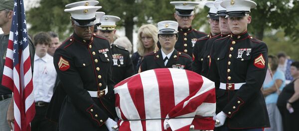 An American flag covers the casket of Lance Cpl. Christopher Fowlkes as it is carried by an honor guard during grave side services Friday, Sept. 18, 2009, in Gaffney, S.C. Fowlkes, 20, died last week from his injuries from a ground bomb on Sept. 3 battle in Helmand province, Afghanistan. - Sputnik International