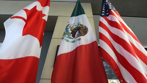 The Mexican, US and the Canadian flags sit in the lobby where the third round of the NAFTA renegotiations are taking place in Ottawa, Ontario, September 24, 2017 - Sputnik International