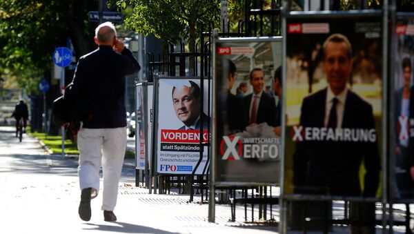 A man walks past an election campaign posters of top candidate of Social Democratic Party of Austria (SPOe) and Austrian Chancellor Christian Kern and far-right Freedom Party of Austria (FPOe) head and top candidate Heinz-Christian Strache in Vienna, Austria, October 5, 2017 - Sputnik International