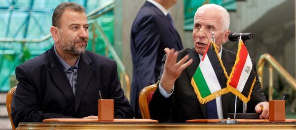 Head of Hamas delegation Saleh Arouri and Fatah leader Azzam Ahmad attend a reconciliation deal signing ceremony in Cairo, Egypt, October 12, 2017. Head of Hamas delegation Saleh Arouri and Fatah leader Azzam Ahmad attend a reconciliation deal signing ceremony in Cairo, Egypt, October 12, 2017. - Sputnik International