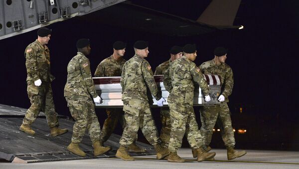 In this image provided by the US Air Force, a US Army carry team transfers the remains of Army Staff Sgt. Dustin Wright of Lyons, Ga., late Thursday, Oct. 5, 2017, upon arrival at Dover Air Force Base, Del. Wright, 29, of Lyons, Ga., was one of four US troops and four Niger forces killed in an ambush by dozens of Islamic extremists on a joint patrol of American and Niger Force. - Sputnik International