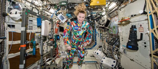This undated handout photo from NASA shows astronaut Kate Rubins aboard the International Space Station wearing a hand-painted spacesuit decorated by childhood cancer patients at the University of Texas MD Anderson Cancer Center in Houston. NASA said Rubins will chat from the space station with patients during a 20-minute call on Friday, Sept. 16, 2016 This undated handout photo from NASA shows astronaut Kate Rubins aboard the International Space Station wearing a hand-painted spacesuit decorated by childhood cancer patients at the University of Texas MD Anderson Cancer Center in Houston. NASA said Rubins will chat from the space station with patients during a 20-minute call on Friday, Sept. 16, 2016 - Sputnik International