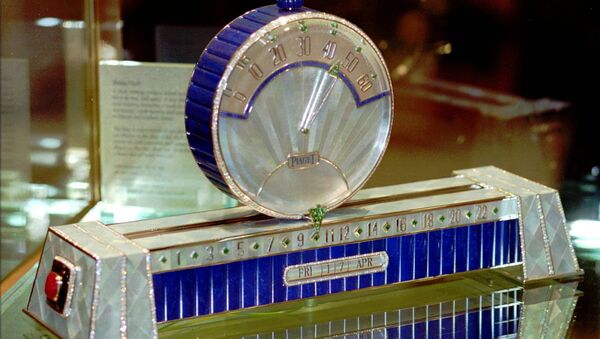 Swiss watch manufacture Piaget with the only model of the Sliding Clock at the 1998 International Fine Watchmaking Exhibition at Geneva, Switzerland. The hours are shown at the base of the clock and the minutes are shown on the disc sliding above the base. The price of these clock, with 926 diamonds (53,27 cts), 50 emeralds (11.63 cts), two rubies, gold weight 930 grams, is some $1.572 million. - Sputnik International