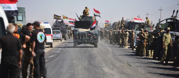 Members of Iraqi federal forces gather to continue to advance in military vehicles in Kirkuk, Iraq - Sputnik International