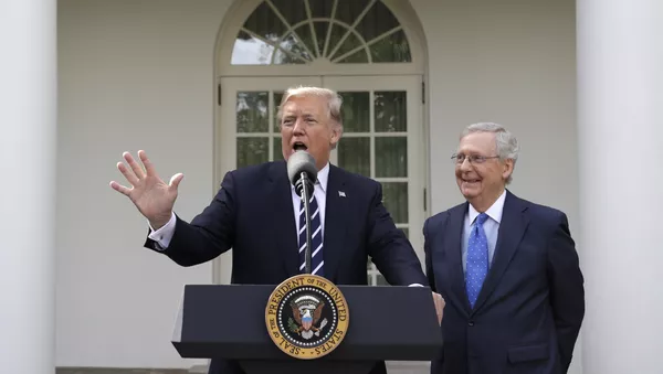President Donald Trump answers questions with Senate Majority Leader Mitch McConnell, R-Ky., in the Rose Garden after their meeting at the White House, Monday, 16 October 2017, in Washington. - Sputnik International