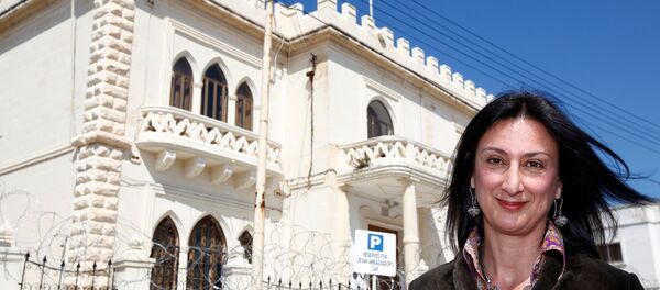 Maltese investigative journalist Daphne Caruana Galizia poses outside the Libyan Embassy in Valletta April 6, 2011. Investigative journalist Caruana Galizia was killed after a powerful bomb blew up a car killing her in Bidnija, Malta, in October 16, 2017. - Sputnik International