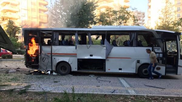 A bus carrying police officers still burning shortly after a bomb went off as the bus was passing by in Mersin in southern Turkey - Sputnik International