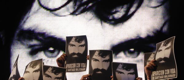 In this Friday, Sept. 1, 2017 photo, demonstrators hold photos of missing activist Santiago Maldonado, during a protest at Plaza de Mayo in Buenos Aires, Argentina. - Sputnik International