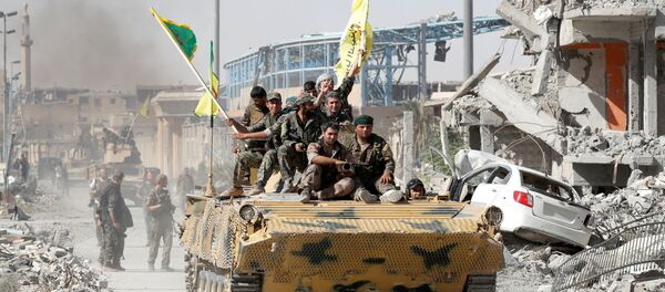 Syrian Democratic Forces (SDF) fighters ride atop of military vehicle as they celebrate victory in Raqqa, Syria, October 17, 2017 Syrian Democratic Forces (SDF) fighters ride atop of military vehicle as they celebrate victory in Raqqa, Syria, October 17, 2017 - Sputnik International
