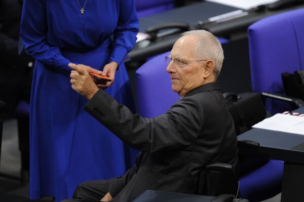 German Finance Minister Wolfgang Schaeuble arrives in the hemicycle prior Germany's newly-elected parliament holds its first sitting in the Reichstag building housing the Bundestag (lower house of parliament) in Berlin on October 24, 2017 German Finance Minister Wolfgang Schaeuble arrives in the hemicycle prior Germany's newly-elected parliament holds its first sitting in the Reichstag building housing the Bundestag (lower house of parliament) in Berlin on October 24, 2017 - Sputnik International
