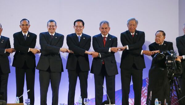 Representatives link arms during a brief photo session at the start of the ASEAN Defense Ministers' Meeting and its Dialogue Partners in Clark, Pampanga province, north of Manila, Philippines - Sputnik International