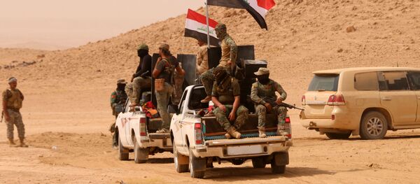 Members of the Iraqi forces backed by paramilitary units advance in an area south of Anna in the vast western province of Anbar bordering Syria, on September 20, 2017 - Sputnik International